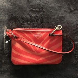Small brand new Coach leather wristlet.